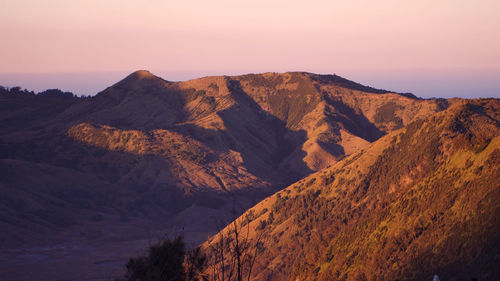 Scenic view of mountain range against sky during sunset