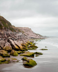 Scenic view of sea and mountains against sky