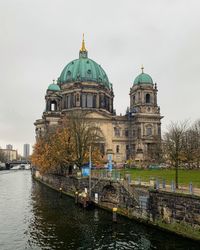 View of church by building against sky