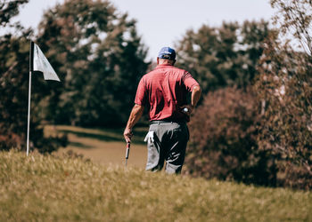 Rear view of man standing on field