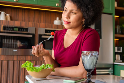 Side view of young woman preparing food in cafe