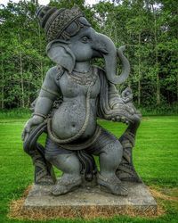 Statue against trees