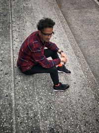 High angle view of young man looking away on road