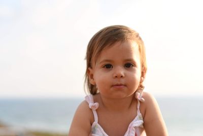 Portrait of cute girl against sky