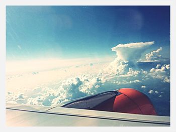 Scenic view of snow covered mountains against blue sky