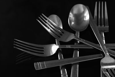 Close-up of electric lamp on table against black background