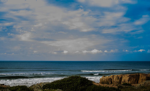 Scenic view of sea against cloudy sky