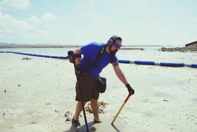 Full length of boy on beach against sky