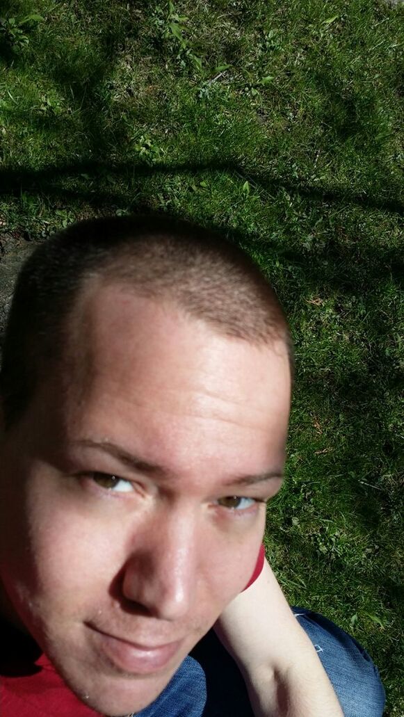 headshot, lifestyles, portrait, looking at camera, person, leisure activity, young adult, front view, close-up, human face, head and shoulders, smiling, young men, green color, day, outdoors, grass