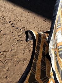 High angle view of shoes on sand at beach