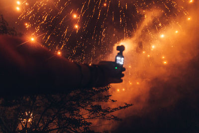 View of fireworks against sky at night - recording video and taking photos with action camera