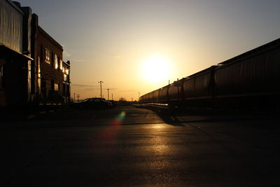 View of road in city at sunset