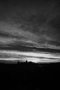 Silhouette of landscape against cloudy sky