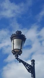 Low angle view of street light against sky