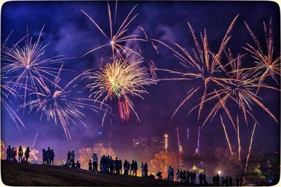 Low angle view of firework display at night