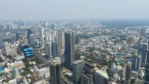 High angle view of modern buildings in city against sky