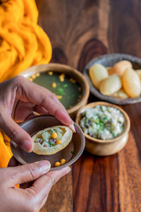 Cropped hand of person holding food