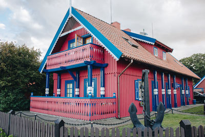 Exterior of house by building against sky