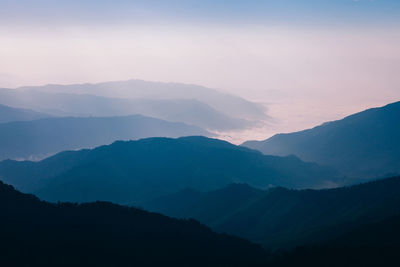 Scenic view of silhouette mountains against sky during sunset