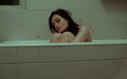 Portrait of young woman in bathtub