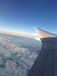 Airplane wing against sky