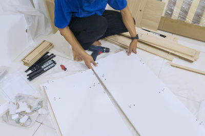 Low section of man standing by building