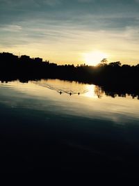 Scenic view of lake at sunset