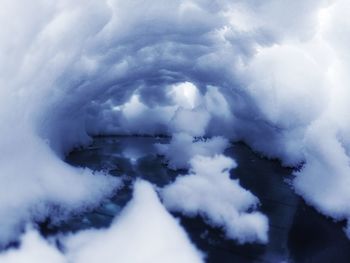 Aerial view of snow covered landscape against sky