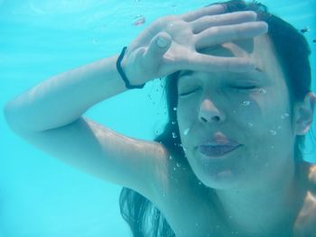 Portrait of woman swimming in pool