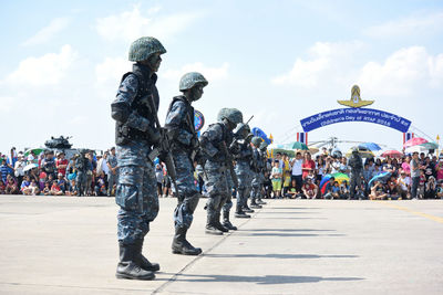 Army soldiers with guns standing on street