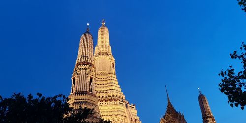 Low angle view of temple building against clear blue sky
