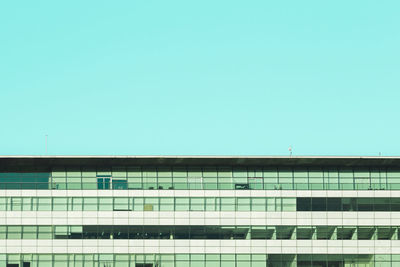 Low angle view of modern building against clear blue sky