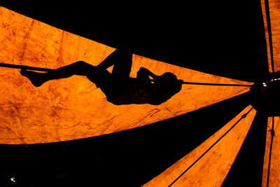 Low angle view of silhouette man against sky