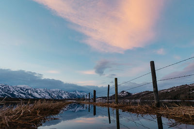 Sunset cloud colors reflect over a flooded wyoming teton ranch