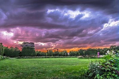 Scenic view of field against cloudy sky