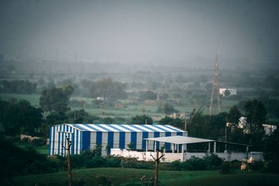 High angle view of building and trees against sky