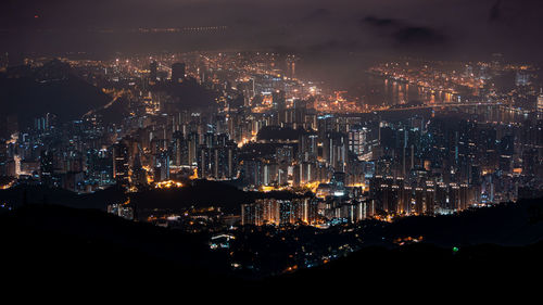 High angle view of illuminated buildings in city at night