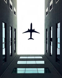 Low angle view of airplane flying against sky