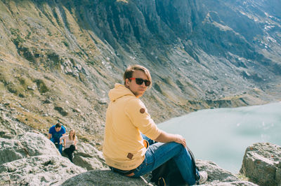 Portrait of young woman standing on mountain