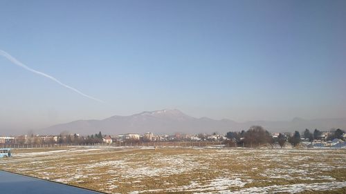 Scenic view of snowy landscape against clear sky