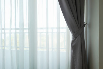 Close-up of curtain against window at home