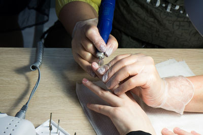 Close-up of hands working on table