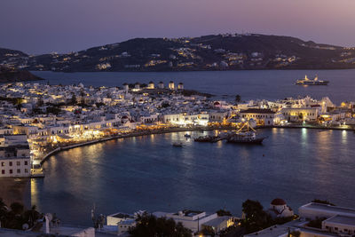 High angle view of townscape by sea against sky