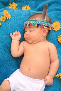 High angle view of baby lying on bed