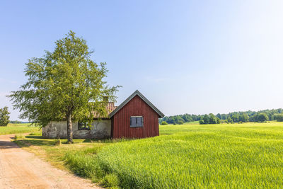 House on field against clear sky