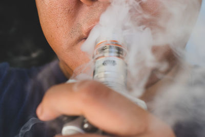 Close-up of man smoking hookah