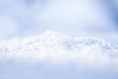 Close-up of snow against blue sky