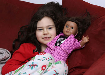 Portrait of smiling young woman sitting on sofa at home