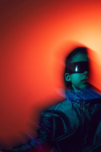 Portrait cyberpunk boy child in vr glasses in blue and red tones with wires. game, virtual reality