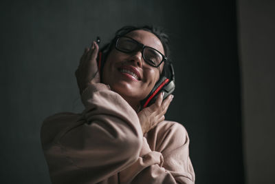 Portrait of smiling young woman using mobile phone